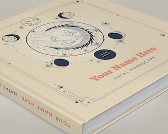 May include: A square hardcover book with a cream-colored cover featuring a dark blue celestial illustration of a sun and moon surrounded by moon phases and stars. The text reads Your Name Here NATAL HOROSCOPE in pink and black lettering.