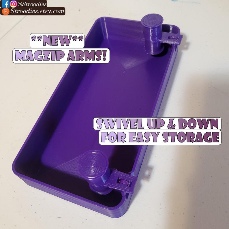 May include: Purple plastic storage container with two swivel arms that can be moved up and down for easy storage. The container has the text "NEW** MAGZIP ARMS!" and "SWIVEL UP & DOWN FOR EASY STORAGE" printed on it.