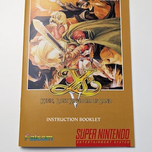 May include: A vintage instruction booklet for the Super Nintendo game "Ys V: Kefin, Lost Kingdom of Sand." The cover features colourful fantasy artwork of characters with swords and capes. The booklet is tan with the Falcom and Super Nintendo logos.