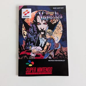 May include: A Super Nintendo instruction booklet for the game Castlevania: Symphony of the Night. The cover features a dark, gothic illustration of a vampire with red eyes and a castle in the background. The text "SNSP-ADZP-EUR" is printed in the top right corner.