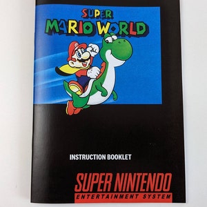 May include: Open instruction booklet for the Super Nintendo game "Super Mario World." The cover features Mario riding Yoshi against a blue background. The booklet is black with the words "Instruction Booklet" and "Super Nintendo Entertainment System."