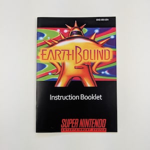 May include: EarthBound instruction booklet for the Super Nintendo Entertainment System. The cover features a gold and orange robot-like figure with the game title in orange and green. The booklet is black with the Super Nintendo logo.
