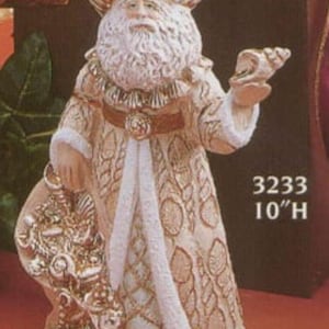 May include: A decorative Santa Claus figurine, approximately 10 inches tall, in cream and gold. The figure has a white beard, a hat, and a robe with intricate patterns. Santa holds a sack and a small object. The text "3233 10"H" is visible.