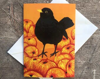 Tarjeta de felicitación con mirlo y manzanas (en blanco por dentro)