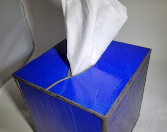May include: A blue stained glass tissue box holder with a white tissue box inside.