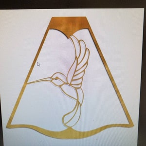 May include: A gold-colored metal hummingbird silhouette cut-out, with a decorative, wavy, scalloped edge.