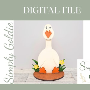 May include: A white wooden goose with orange feet and a yellow beak, sitting on a brown wooden base with green grass and yellow flowers. The goose is a decorative item and is part of a digital file.