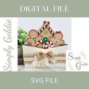 May include: A white wooden envelope with a gingerbread house, two gingerbread people, and a red and white candy cane. The envelope is decorated with burlap ribbon and a bow.