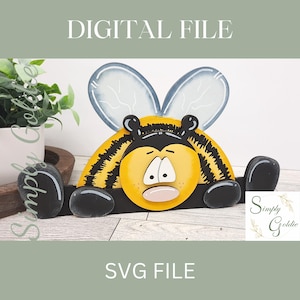 May include: A digital file for a DIY wooden bee craft project. The bee is yellow and black with a cute cartoon face and large wings. The file is an SVG file.