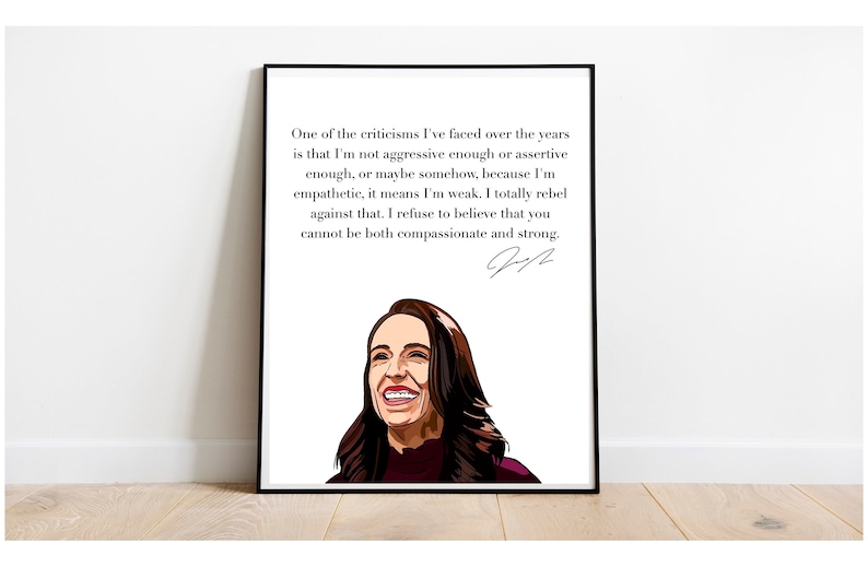 May include: A black and white framed print with a quote by Jacinda Ardern, Prime Minister of New Zealand. The quote reads: "One of the criticisms I've faced over the years is that I'm not aggressive enough or assertive enough, or maybe somehow, because I'm empathetic, it means I'm weak. I totally rebel against that. I refuse to believe that you cannot be both compassionate and strong." The quote is signed "JA".