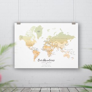 May include: A world map with a gradient of orange and green colours. The map is titled "Our Adventures" with the names Laura & Andrew below. The map is designed to be used as a travel tracker.