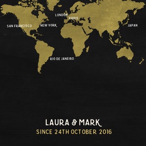 May include: A world map in gold against a black background, with major cities labeled. The names "Laura & Mark" and the date "24th October 2016" are printed below the map. The map is a decorative piece.