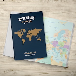 May include: A blue travel journal with a gold world map and the text "Adventure awaits" on the cover. The journal also has the text "A book of travels, places been, going, one day." on the cover. The journal is open to a world map.
