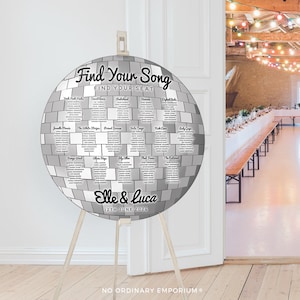 May include: A silver disco ball seating chart with a black and white design. The chart is labeled "Find Your Song" and features a list of names and song titles. The chart is on a wooden easel and the text at the bottom reads "Elle & Luca 12th June 2024".