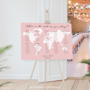 A pink wedding seating chart with a white outline of the world map. The chart is divided into sections for different countries, with guest names listed under each country. The text at the top reads "Where in the world are you sitting?" and the bottom reads "Sophia & Mike 25th August 2019".