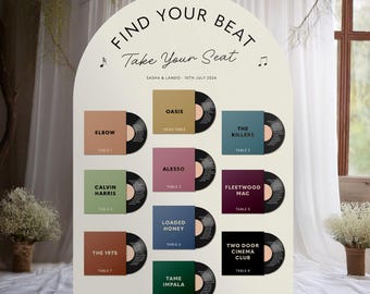 May include: A white, arched wedding seating chart with the text "Find Your Beat, Take Your Seat". It features album art for various bands, including Oasis, The Killers, and Fleetwood Mac, with table numbers. The date "10th July 2024" is also displayed.