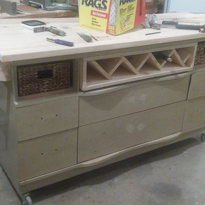 This recycled dresser makes the perfect kitchen island-With a handy wine rack crafted right in front and matching baskets-and slick design image 9