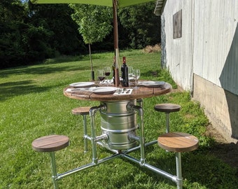 Cafe/restaurant picnic table furnishings from beer kegs with 4 built in seats with galvanized steel pipe and a solid wood top with 4 seats