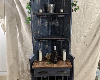 Corner wine bar from a upcycled door, with a wine storage bin, and a place for 6 of your favorite wine glasses, fits nicely in any corner.
