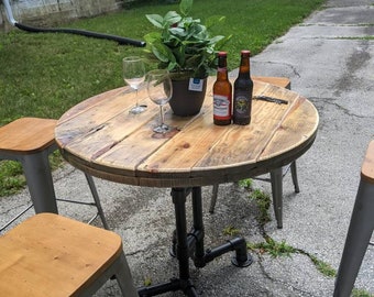 Cafe/restaurant style table using galvanized steel pipe and a solid wood top, shown with spool top optional hard wood tops available