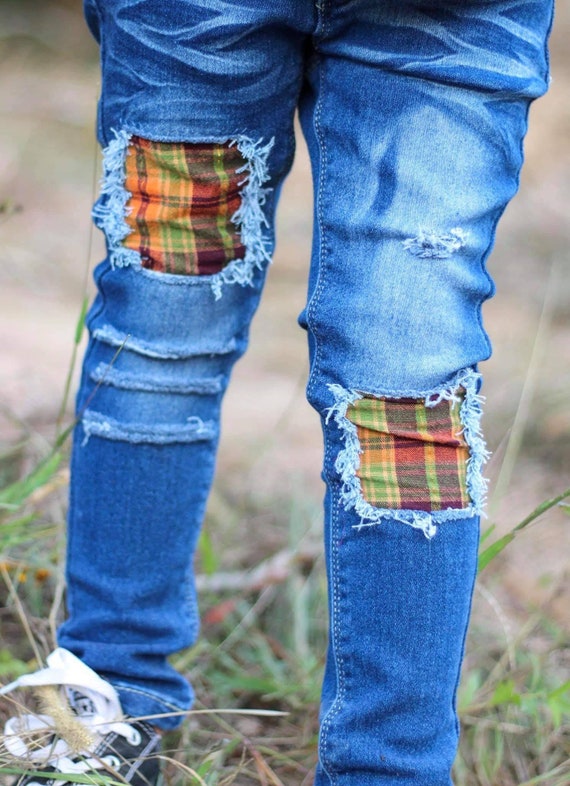 ripped jeans with plaid patches