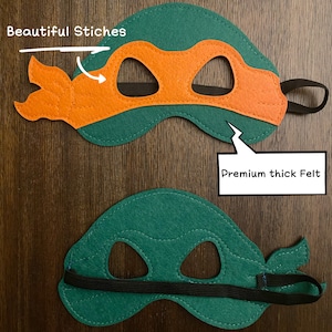May include: Green and orange felt Teenage Mutant Ninja Turtles mask with black elastic band. The mask has detailed stitching and the text "Beautiful Stitches" and "Premium thick Felt" are written on the image.