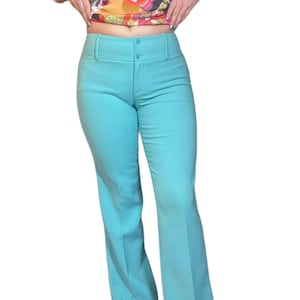 1990s Dolce and Gabbana turquoise pure wool pants, brown contrast striping at side of legs, brown leather D&G patch w horseshoes, designer