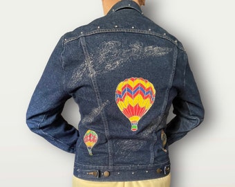 1970s dark denim jacket with studs and hand-painted hot air balloons, glitter