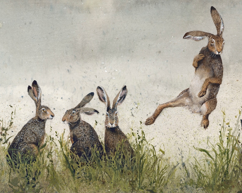 May include: A watercolor painting of four brown hares. Three hares are sitting in a field of green grass, while the fourth hare is standing on its hind legs and stretching its front legs out in front of it.