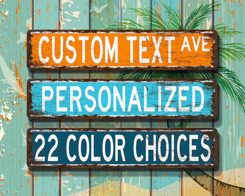 May include: Three rectangular wooden signs with white text against a distressed background. The top sign is orange and reads "CUSTOM TEXT AVE". The middle sign is blue and says "PERSONALIZED". The bottom sign is dark blue and says "22 COLOUR CHOICES".