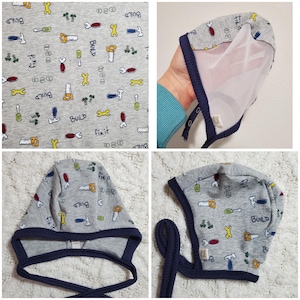 May include: A white ceramic mug with a black handle and the text "But First, Coffee" in a bold, black font. The mug is set against a blurred background, suggesting a cozy setting.