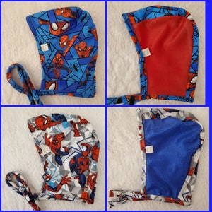May include: A blue and red hooded hat with a Spiderman pattern. The hat has a mesh lining and a tie string.