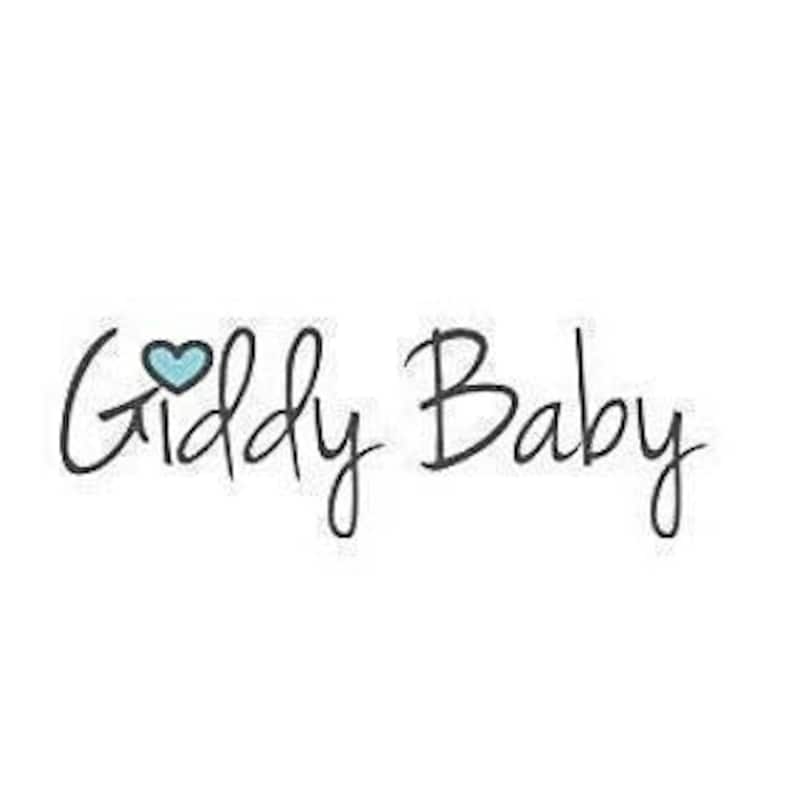 May include: The text Giddy Baby is written in a black, handwritten-style font. A small, light blue heart with a dark blue outline is positioned above the letter i in the word Giddy, replacing the standard dot on the lowercase letter i.