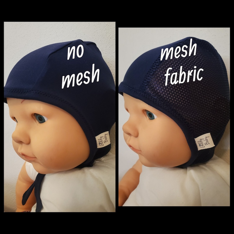 May include: Two navy blue baby bonnets shown on a doll. The left bonnet is solid fabric with the text no mesh. The right bonnet features a side panel of mesh fabric with the text mesh fabric. Both bonnets have a small white tag labeled Giddy Baby.
