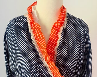 May include: A navy blue and white polka dot robe with a red and white polka dot trim and a matching tie belt.