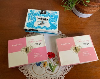 May include: Three boxes of tights, two are pink and white with the text "Kolotex Free-n-cay Clinga 40 denier Seamless Stretch" and one is blue and white with the text "Worth 60 denier Satin Stretch Seamless Guarantee".