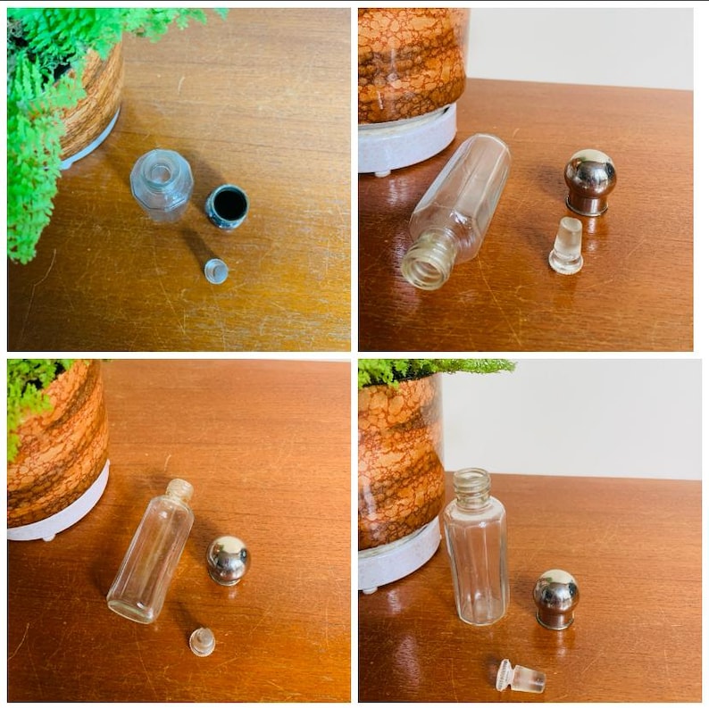 May include: Four glass bottles with stoppers. The bottles are clear and have a cylindrical shape. The stoppers are silver and have a round shape. The bottles are on a wooden surface.