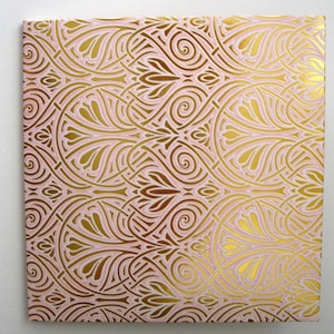May include: A pink and gold patterned wrapping paper with a repeating design of swirls and leaves.