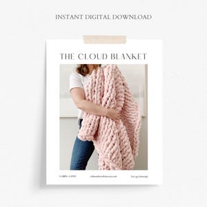 May include: A pink chunky knit blanket, called "The Cloud Blanket", is held by a person in a white t-shirt and blue jeans. The text "Cabin Cove" and "cabinandcoveknits.etsy.com" are at the bottom of the image.