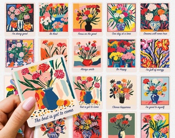 May include: Twenty colorful floral stickers with inspirational quotes. Each sticker features a bouquet of flowers in a vase with a different background color and design. The quotes include "I'm doing good", "Be Kind", "Focus on the good", "One day at a time", "Dreams will come true", "The best is yet to come", "Always smile", "Be Happy", "I'm full of energy", "Best is yet to come", "Choose happiness", "I'm good to myself", "Let it blossom", "Take a break", "Today is a great day", and "I am loved".