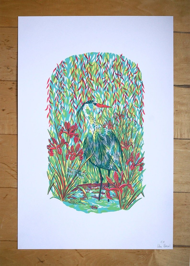 May include: A blue heron stands in a pond surrounded by green and red irises and a dragonfly. The background is a blue and green pattern of leaves.