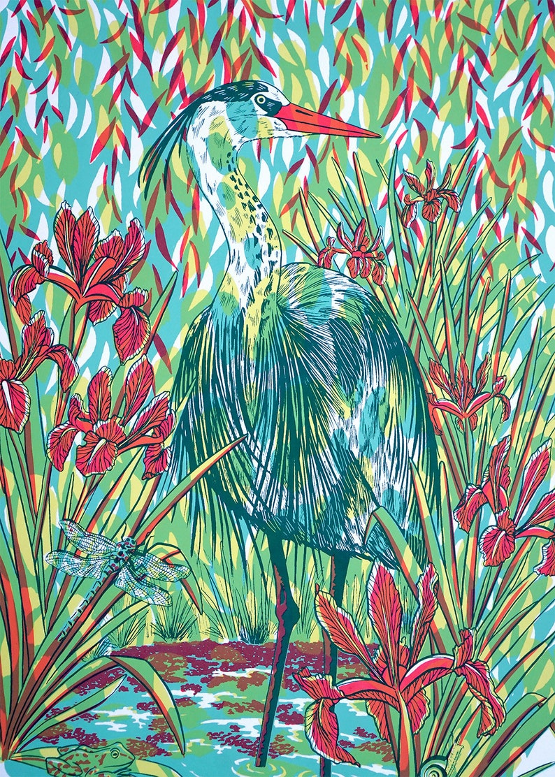 May include: A blue heron stands in a marsh with green reeds and red iris flowers. A dragonfly is perched on a reed in the foreground. The background is a vibrant turquoise and green.