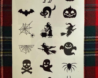 May include: Sheet of black Halloween-themed temporary tattoos. Designs include bats, cats, jack-o'-lanterns, spiderwebs, spiders, witches, ghosts, and skulls with crossbones. The tattoos are arranged on a white background.