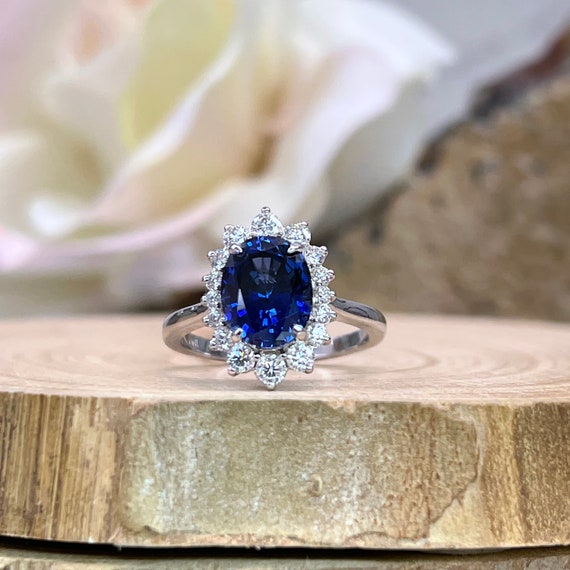 14k White Gold Oval Created Blue Sapphire & Diamond Halo Ring 14k White Gold Oval Created Blue Sapphire & Diamond Halo Ring