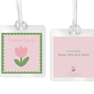 May include: Two pink and green luggage tags with a tulip design. The first tag says "Lindsey Smith" and the second tag says "Contact Info Mom: 901-412-2660 The Four Seasons www.etsy.shop/TheFourSeasons".