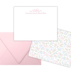 May include: A pink envelope with a white card featuring a floral design and the text "from the nursery of Emma Grace".