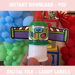 May include: A candy label featuring a Buzz Lightyear design, with a green and white body, red accents, and wings. The image includes text that reads "INSTANT DOWNLOAD - PDF" and "DIGITAL FILE - CANDY LABELS". Balloons in blue, yellow, and red are in the background.