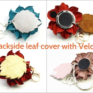 May include: A collection of flower-shaped keychains in various colors, including teal, red, and mauve. Each keychain features a leaf-shaped backing with Velcro and a metal clasp. The text "Backside leaf cover with Velcro" is visible.