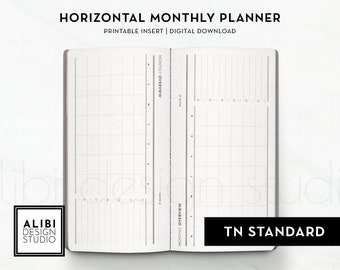May include: A horizontal monthly planner printable insert and digital download featuring a white open notebook with black grid lines, columns for days of the week, and the text "MONTHLY OVERVIEW" and "TN STANDARD" printed on the pages.