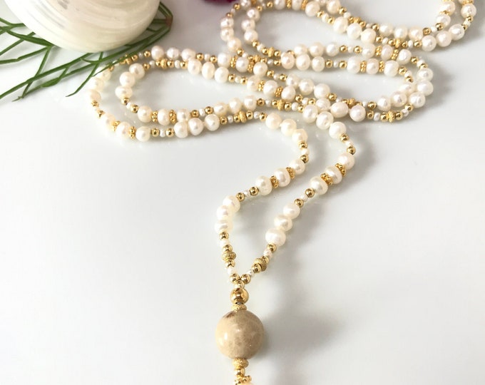 Noble, delicate mala made of freshwater pearls (A), decorated with gold-plated silver, final pearl made of petrified coral